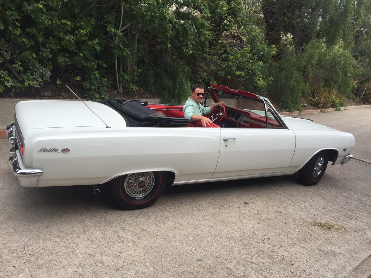 Michael Olguin driving a classic Malibu convertible