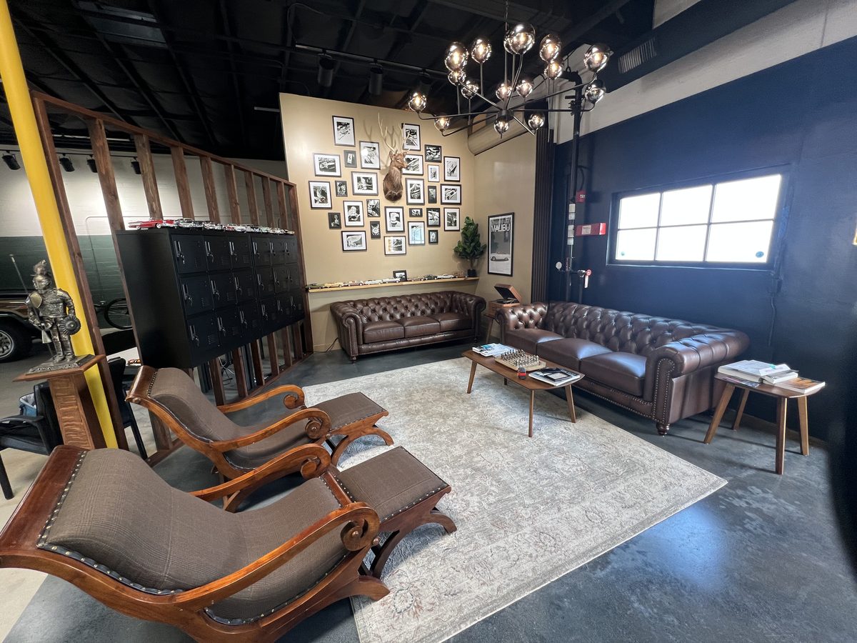 The Lounge — leather couches, Chesterfield sofas, and chandelier