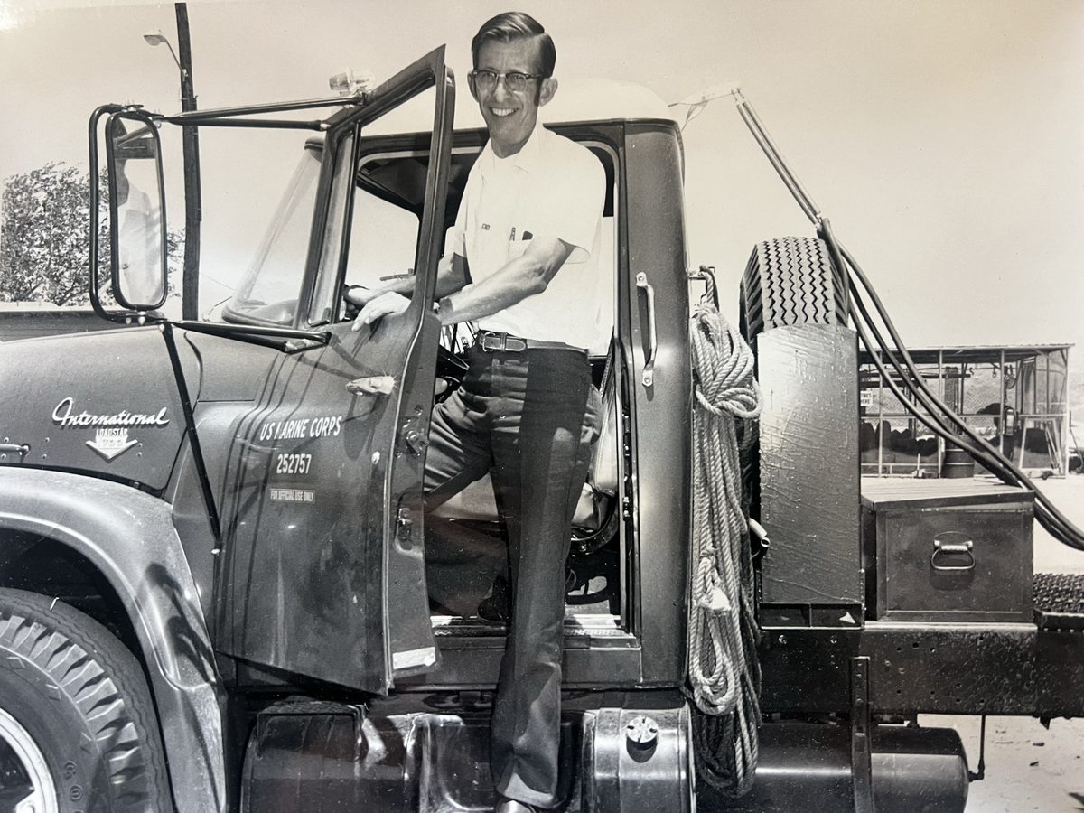 Gillie Olguin standing on his International truck